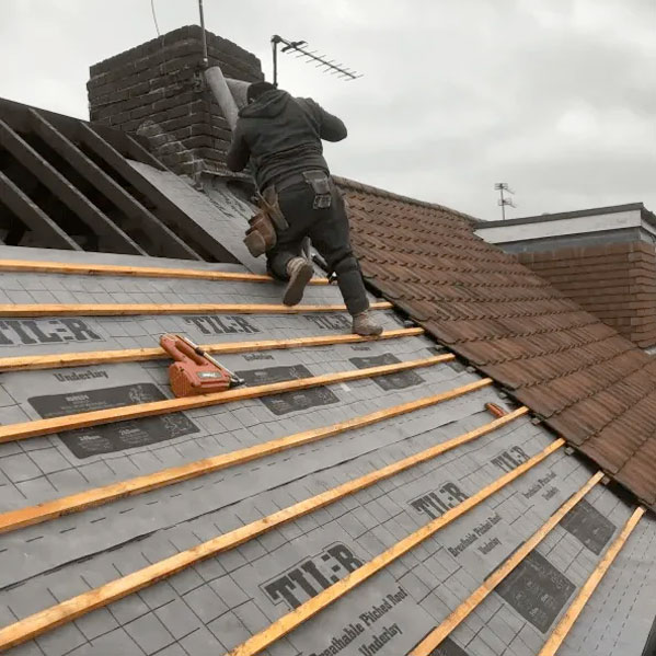 professional-roofers Cooks & Co Ltd placing roof tiles
